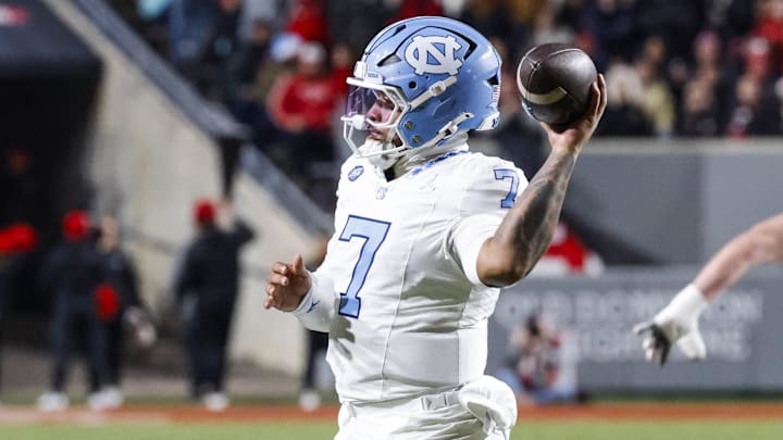 Nov 29, 2025; Raleigh, North Carolina, USA;  North Carolina Tar Heels quarterback Gio Lopez (7) prepares to throw the football during the first half of the game against NC State Wolfpack at Carter-Finley Stadium.  Mandatory Credit: Jaylynn Nash-Imagn Images