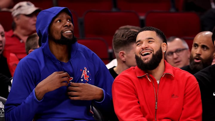 Nov 12, 2025; Houston, Texas, USA; Houston Rockets forward Kevin Durant (7) sits next to Houston Rockets guard Fred VanVleet (5, red) on the bench against the Washington Wizards during the fourth quarter at Toyota Center. Mandatory Credit: Erik Williams-Imagn Images