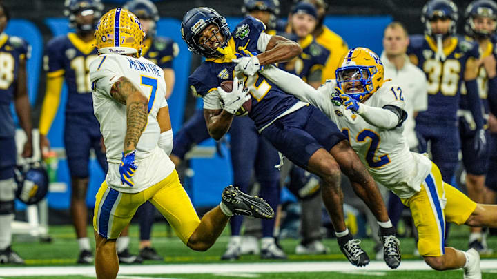Toledo Rockets wide receiver Junior Vandeross III (2) makes a catch to get the first down against Pittsburgh Panthers defensive back Cruce Brookins (12) that lead to a tying field goal, in the fourth quarter of the 2024 GameAbove Sports Bowl at Ford Field in Detroit, on Thursday, Dec. 26, 2024.