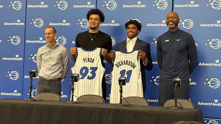 Orlando Magic draft picks Jase Richardson and Noah Penda pose with their jerseys at introductory press conference. 