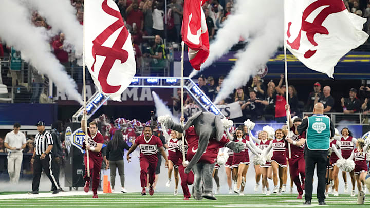 Big Al and the Alabama cheerleaders lead the Crimson Tide onto the field before the 2021 College Football Playoff Semifinal game at the 86th Cotton Bowl in AT&T Stadium in Arlington, Texas Friday, Dec. 31, 2021. Alabama defeated Cincinnati 27-6 to advance to the national championship game. [Staff Photo/Gary Cosby Jr.]