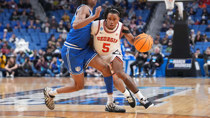 Mar 19, 2026; Buffalo, NY, USA; Georgia Bulldogs guard Jeremiah Wilkinson (5) dribbles the ball against Saint Louis Billikens guard Quentin Jones (1) during the second half of a first round game of the men's 2026 NCAA Tournament at Keybank Center. Mandatory Credit: Gregory Fisher-Imagn Images