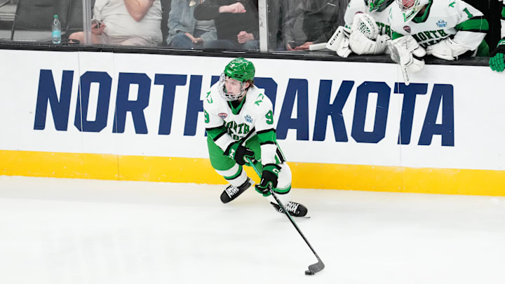 Apr 9, 2026; Las Vegas, Nevada, UNITED STATES; North Dakota Fighting Hawks forward Will Zellers (9) moves the puck in the second period against the Wisconsin Badgers in the semifinals of the NCAA men's ice hockey Frozen Four at T-Mobile Arena. Mandatory Credit: Stephen R. Sylvanie-Imagn Images