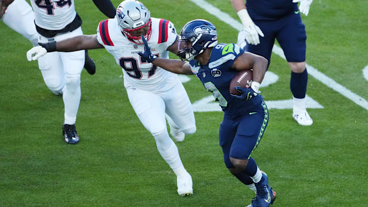 Feb 8, 2026; Santa Clara, CA, USA; Seattle Seahawks running back Kenneth Walker III (9) runs past New England Patriots defensive end Milton Williams (97) in the first half in Super Bowl LX at Levi's Stadium. Mandatory Credit: Kirby Lee-Imagn Images