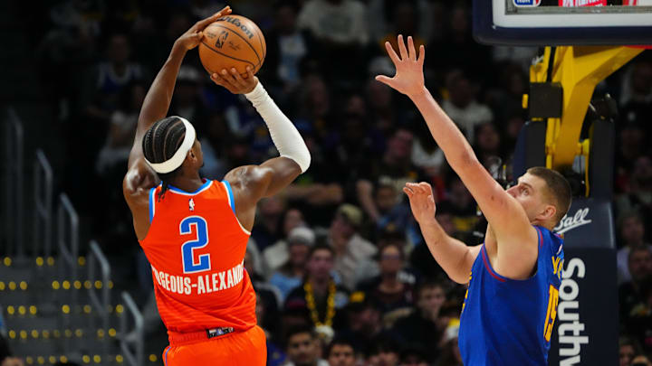 Dec 16, 2023; Denver, Colorado, USA; Oklahoma City Thunder guard Shai Gilgeous-Alexander (2) shoots over Denver Nuggets center Nikola Jokic (15)