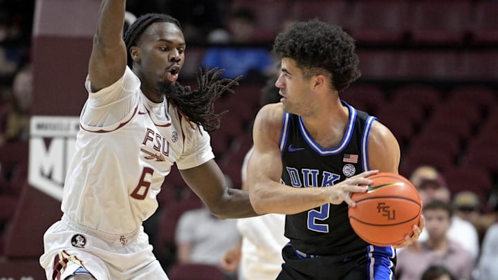 Jan 3, 2026; Tallahassee, Florida, USA; Duke Blue Devils guard Cayden Boozer (2) looks to pass the ball as he is defended by Florida State Seminoles guard Robert McCray (6) during the first half at Donald L. Tucker Center. Mandatory Credit: Melina Myers-Imagn Images Jan 3, 2026; Tallahassee, Florida, USA; Duke Blue Devils guard Cayden Boozer (2) looks to pass the ball as he is defended by Florida State Seminoles guard Robert McCray (6) during the first half at Donald L. Tucker Center. Mandatory Credit: Melina Myers-Imagn Images