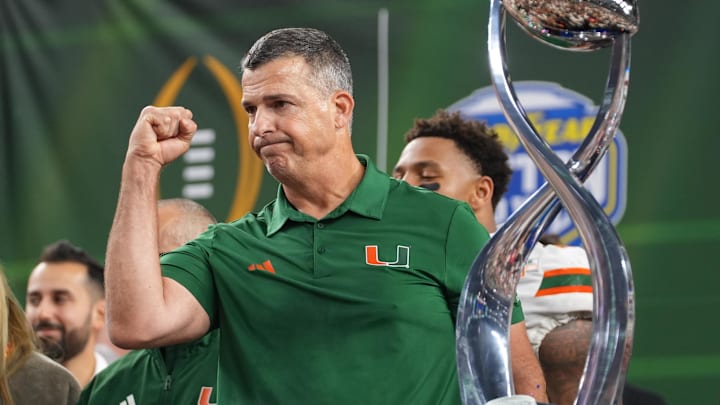 Dec 31, 2025; Arlington, TX, USA; Miami Hurricanes head coach Mario Cristobal with the champions trophy following the 2025 Cotton Bowl and quarterfinal game of the College Football Playoff against the Ohio State Buckeyes at AT&T Stadium. Mandatory Credit: Raymond Carlin III-Imagn Images
