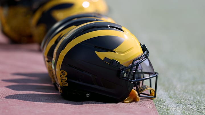 Sep 6, 2025; Norman, Oklahoma, USA; Michigan Wolverine helmets sit on the field near the sideline prior to a game against the Oklahoma Sooners at Gaylord Family-Oklahoma Memorial Stadium. Mandatory Credit: Kevin Jairaj-Imagn Images