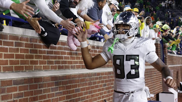 Nov 2, 2024; Ann Arbor, Michigan, USA;  Oregon Ducks tight end Roger Saleapaga (83) celebrates with fans after the game against the Michigan Wolverines at Michigan Stadium. Mandatory Credit: Rick Osentoski-Imagn Images