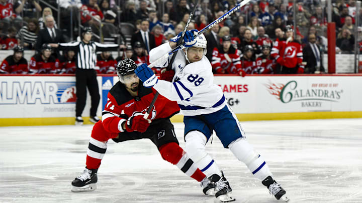 Apr 9, 2024; Newark, New Jersey, USA; Toronto Maple Leafs right wing William Nylander (88) tries to skate past New Jersey Devils defenseman Jonas Siegenthaler (71) during the third period at Prudential Center. Mandatory Credit: John Jones-Imagn Images