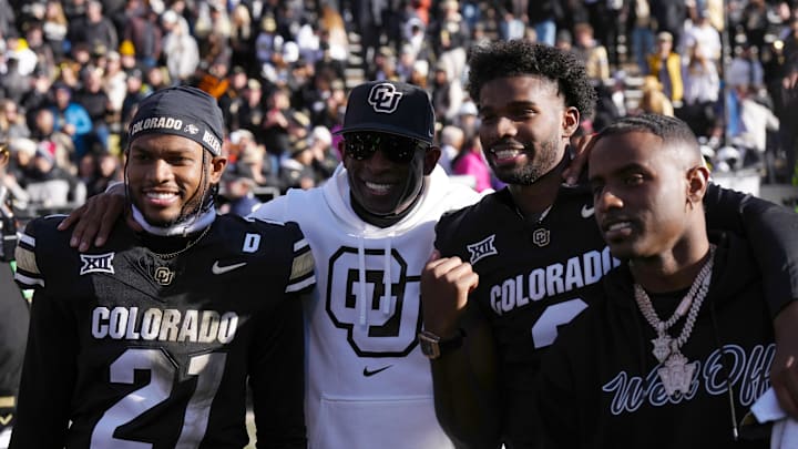 Nov 29, 2024; Boulder, Colorado, USA; Colorado Buffaloes safety Shilo Sanders (21) and head coach Deion Sanders and quarterback Shedeur Sanders (2) and social media producer Deion Sanders Jr. following the win against the Oklahoma State Cowboys at Folsom Field.