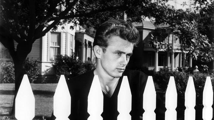 James Dean standing next to white picket fence James Dean standing next to white picket fence