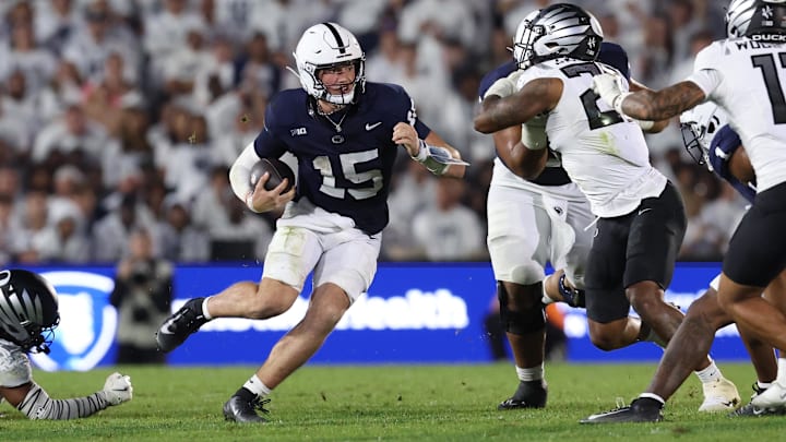 Penn State football quarterback Drew Allar (15) runs for a gain during the fourth quarter against the Oregon Ducks at Beaver Stadium