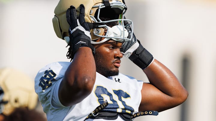 Notre Dame defensive lineman Bryce Young puts on his helmet during a football practice at Irish Athletic Center on Friday, Aug. 15, 2025, in South Bend.