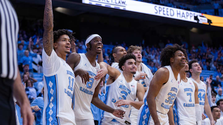 Dec 22, 2025; Chapel Hill, North Carolina, USA; North Carolina Tar Heels forward Jonathan Powell (11), forward Caleb Wilson (8), and guard Derek Dixon (3) react during the second half against the East Carolina Pirates at Dean E. Smith Center. Mandatory Credit: Scott Kinser-Imagn Images