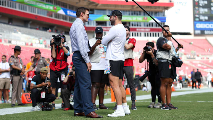 Sep 29, 2024; Tampa, Florida, USA; Fox NFL broadcaster and former NFL quarterback Tom Brady speaks to Tampa Bay Buccaneers quarterback Baker Mayfield (6) before a game against the Philadelphia Eagles at Raymond James Stadium. Sep 29, 2024; Tampa, Florida, USA; Fox NFL broadcaster and former NFL quarterback Tom Brady speaks to Tampa Bay Buccaneers quarterback Baker Mayfield (6) before a game against the Philadelphia Eagles at Raymond James Stadium.