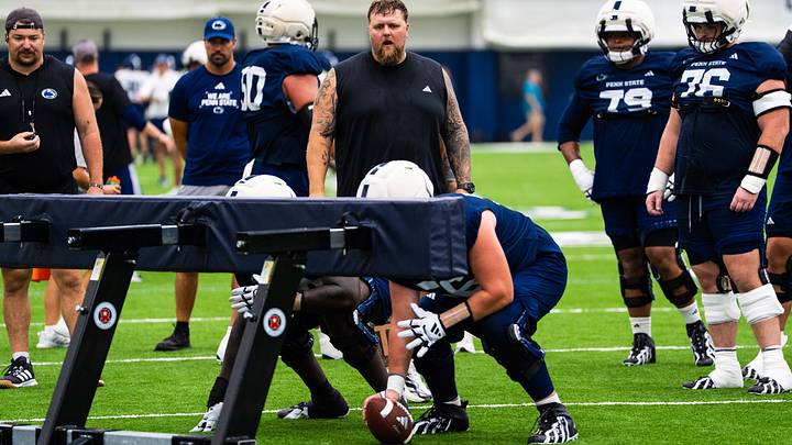 Penn State Nittany Lions offensive line coach Ryan Clanton, center, watches a drill during a practice session inside Holuba Hall. 