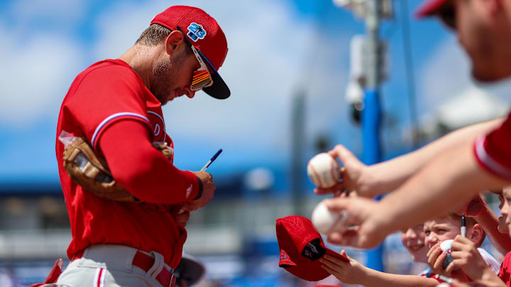 Philadelphia Phillies shortstop Trea Turner (7) signs autographs for fans before a game against the Toronto Blue Jays during spring training at TD Ballpark.