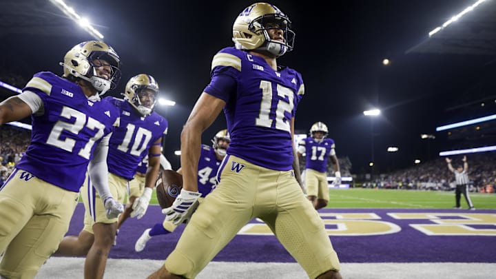 Washington Huskies wide receiver Denzel Boston celebrates after returning a punt for a touchdown.