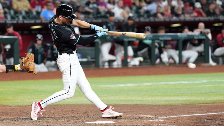 Jun 30, 2024; Phoenix, Arizona, USA; Arizona Diamondbacks pinch hitter Blaze Alexander (9) hits a two RBI single against the Oakland Athletics during the seventh inning at Chase Field. Mandatory Credit: Joe Camporeale-USA TODAY Sports