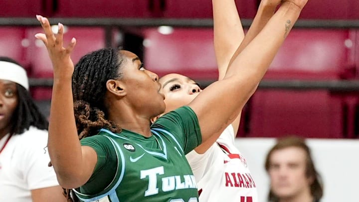 Dec 17, 2025; Tuscaloosa, AL, USA; Tulane forward Amira Mabry (23) and Alabama guard Ta'mia Scott (15) battle for a rebound at Coleman Coliseum. Mandatory Credit: Gary Cosby Jr.-Tuscaloosa News