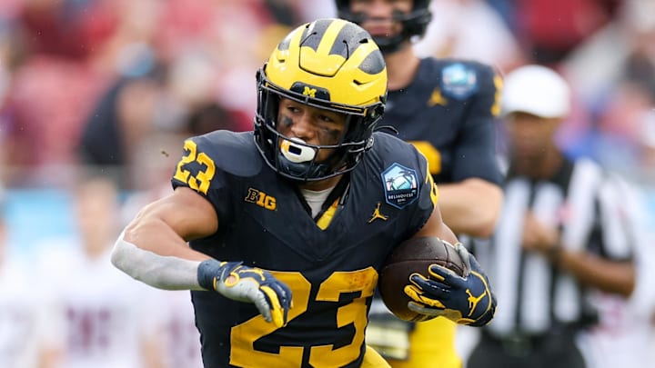 Dec 31, 2024; Tampa, FL, USA; Michigan Wolverines running back Jordan Marshall (23) runs with the ball against the Alabama Crimson Tide in the first quarter  during the ReliaQuest Bowl at Raymond James Stadium. Mandatory Credit: Nathan Ray Seebeck-Imagn Images