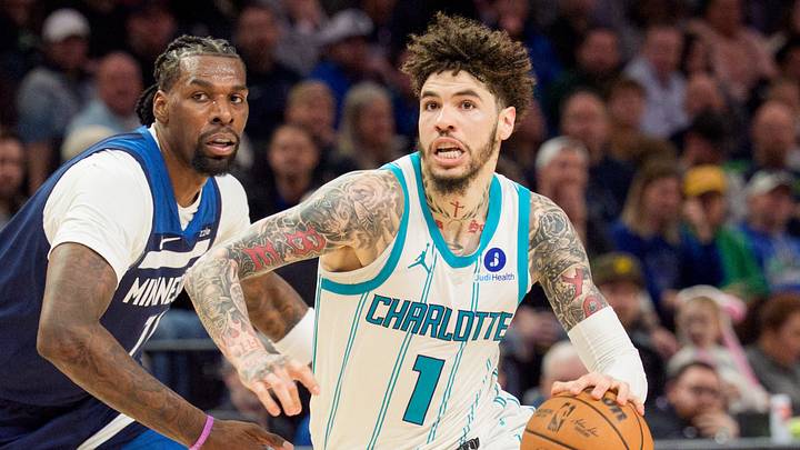 Charlotte Hornets guard LaMelo Ball (1) drives by Minnesota Timberwolves center Naz Reid Charlotte Hornets guard LaMelo Ball (1) drives by Minnesota Timberwolves center Naz Reid