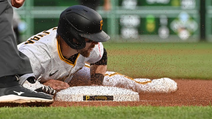 Jun 9, 2025; Pittsburgh, Pennsylvania, USA;  Pittsburgh Pirates base runner Brett Sullivan slides safely into third base during a single in the third inning against the Miami Marlins during the first inning at PNC Park. Mandatory Credit: Philip G. Pavely-Imagn Images