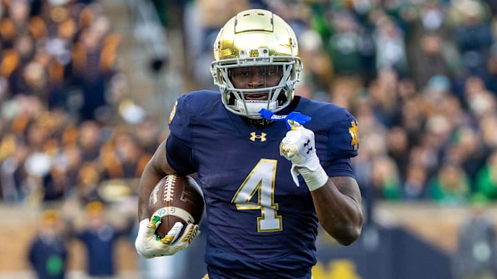 Nov 22, 2025; South Bend, Indiana, USA; Notre Dame Fighting Irish running back Jeremiyah Love (4) runs for a touchdown against the Syracuse Orange during the first half at Notre Dame Stadium. Mandatory Credit: Michael Caterina-Imagn Images