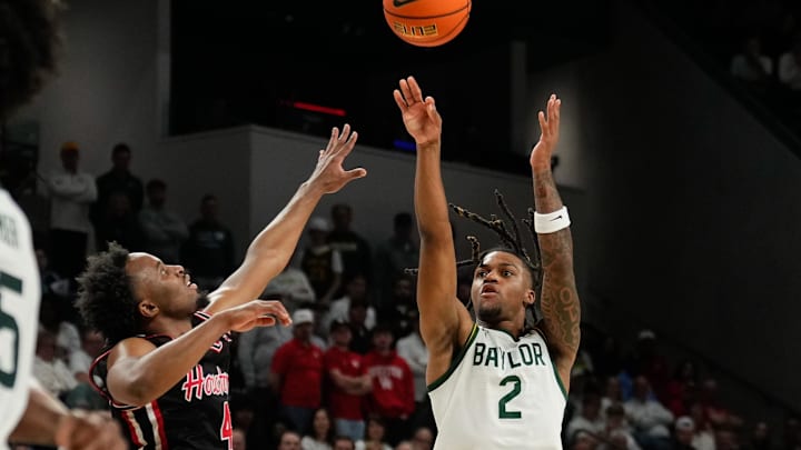 Mar 8, 2025; Waco, Texas, USA; Baylor Bears guard Jayden Nunn (2) scores a three-point basket against Houston Cougars guard L.J. Cryer (4) during the second half at Paul and Alejandra Foster Pavilion. Mandatory Credit: Chris Jones-Imagn Images