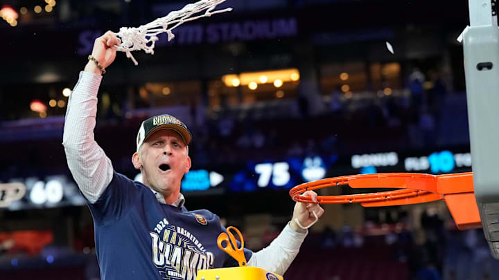 Connecticut Huskies head coach Dan Hurley cuts the basketball net winning the Men's NCAA national championship game against the Purdue Boilermakers at State Farm Stadium in Glendale on April 8, 2024.