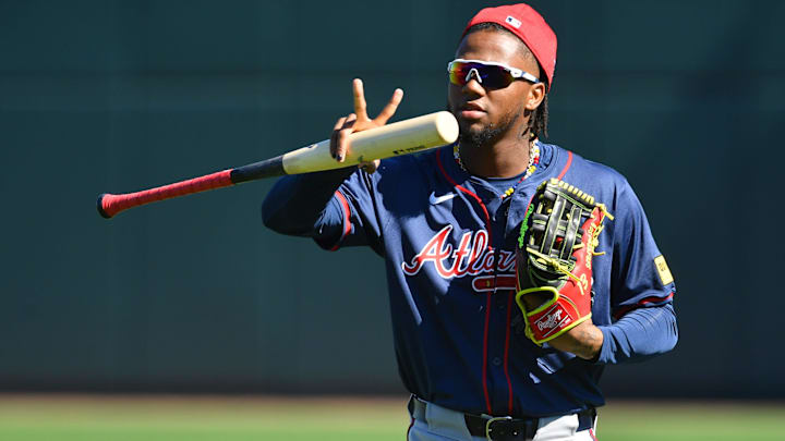 Atlanta Braves outfielder Ronald Acuna, Jr. makes a sign for a video drone following players as the