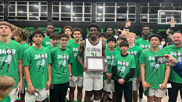 Tounde Yessoufou stands alone among all his teammates Saturday after breaking the California High School career scoring record for St. Joseph High School in Santa Maria.