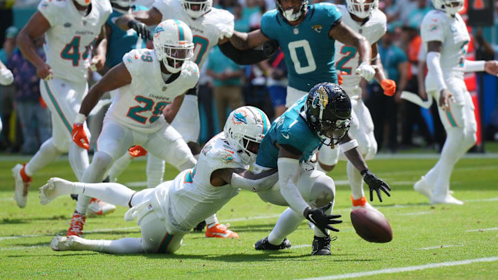 Miami Dolphins safety Jevon Holland (8) punches the ball away from Jacksonville Jaguars running back Travis Etienne Jr. (1) causing a fumble that was recovered by the Dolphins in the end zone during the third quarter at Hard Rock Stadium. Miami Dolphins safety Jevon Holland (8) punches the ball away from Jacksonville Jaguars running back Travis Etienne Jr. (1) causing a fumble that was recovered by the Dolphins in the end zone during the third quarter at Hard Rock Stadium.