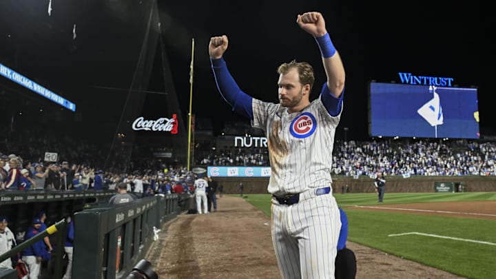 Apr 22, 2025; Chicago, Illinois, USA;  Chicago Cubs outfielder Ian Happ (8) raises his arms after the game against the Los Angeles Dodgers at Wrigley Field. 