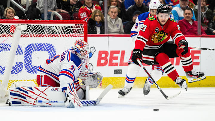 Feb 9, 2024; Chicago, Illinois, USA; Chicago Blackhawks center Philipp Kurashev (23) jumps off the ice as New York Rangers goaltender Igor Shesterkin (31) defends his goal during the first period at the United Center. Mandatory Credit: Daniel Bartel-Imagn Images