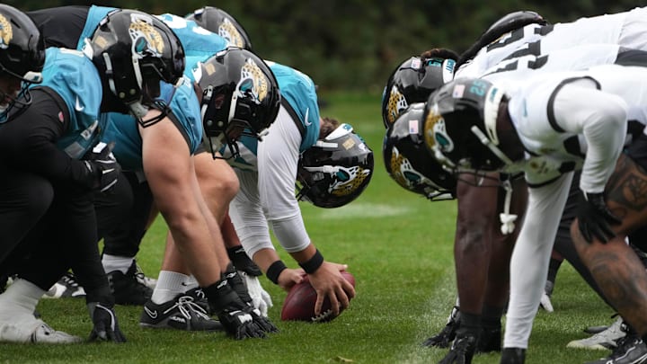 Oct 16, 2024; Watford, United Kingdom; A general overall view of helmets at the line of scrimmage as Jacksonville Jaguars long snapper Ross Matiscik (46) snaps the ball during practice at The Grove. Mandatory Credit: Kirby Lee-Imagn Images