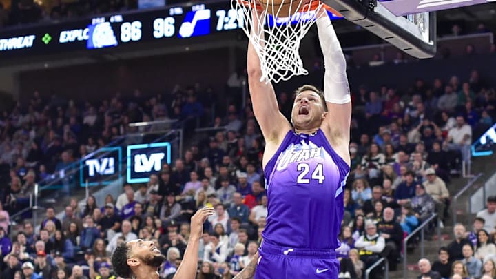 Nov 23, 2024; Salt Lake City, Utah, USA; Utah Jazz center Walker Kessler (24) dunks over New York Knicks guard Cameron Payne (1) during the second half at the Delta Center. Mandatory Credit: Christopher Creveling-Imagn Images