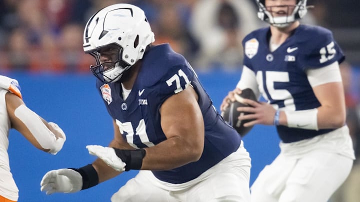 Dec 31, 2024; Glendale, AZ, USA; Penn State Nittany Lions offensive lineman Olaivavega Ioane (71) blocks for quarterback Drew Allar (15) against the Boise State Broncos in the Fiesta Bowl at State Farm Stadium. Mandatory Credit: Mark J. Rebilas-Imagn Images