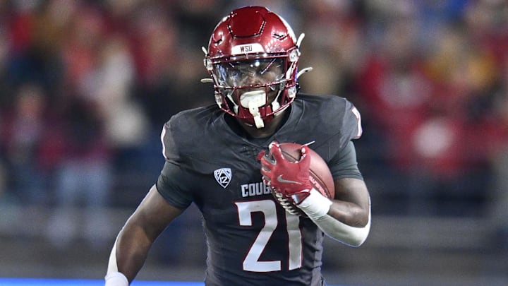 Nov 9, 2024; Pullman, Washington, USA; Washington State Cougars running back Wayshawn Parker (21) runs the ball against the Utah State Aggies in the first half at Gesa Field at Martin Stadium