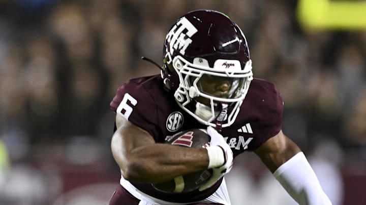 Nov 16, 2024; College Station, Texas, USA; Texas A&M Aggies wide receiver Cyrus Allen (6) attempts to break a tackle from New Mexico State Aggies safety Tayden Barnes (3) during the first half at Kyle Field. Mandatory Credit: Maria Lysaker-Imagn Images 