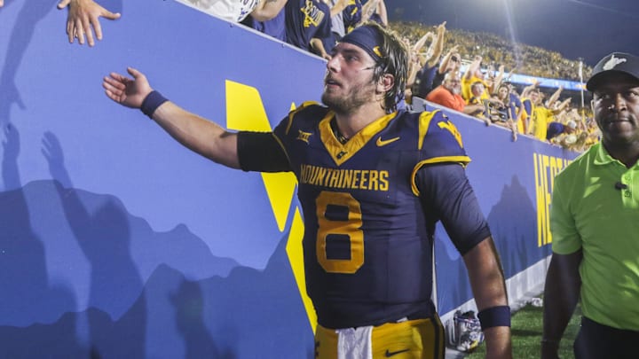 Sep 13, 2025; Morgantown, West Virginia, USA; West Virginia Mountaineers quarterback Nicco Marchiol (8) celebrates with fans after defeating the Pittsburgh Panthers at Milan Puskar Stadium. Mandatory Credit: Ben Queen-Imagn Images