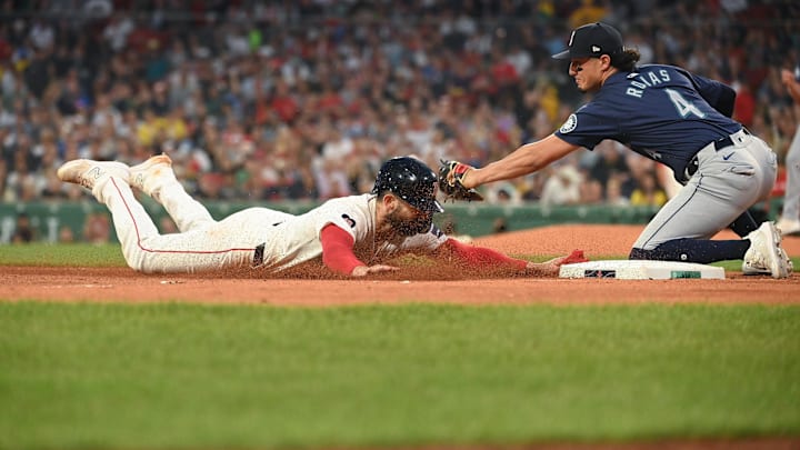 Seattle Mariners third baseman Josh Rojas (left) tags out a runner during a game against the Boston Red Sox on July 29 at Fenway Park. Seattle Mariners third baseman Josh Rojas (left) tags out a runner during a game against the Boston Red Sox on July 29 at Fenway Park.