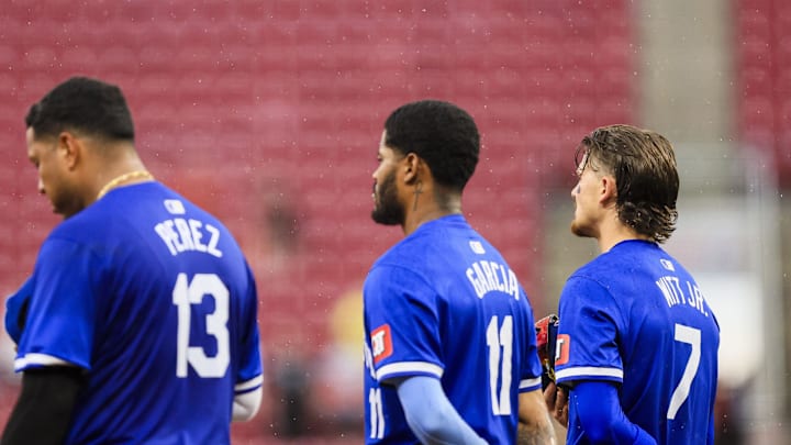 Aug 18, 2024; Cincinnati, Ohio, USA; Kansas City Royals shortstop Bobby Witt Jr. (7), third baseman Maikel Garcia (11), and first baseman Salvador Perez (13) stand on the field during the singing of God Bless America during the seventh inning against the Cincinnati Reds at Great American Ball Park. Mandatory Credit: Katie Stratman-Imagn Images