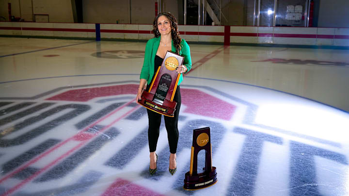 Ohio State women’s hockey head coach Nadine Muzerall poses for a portrait with the 2022 and 2024 National Championship trophies at Ohio State University Ice Rink on Wednesday, Jan. 7, 2026 in Columbus, Ohio.