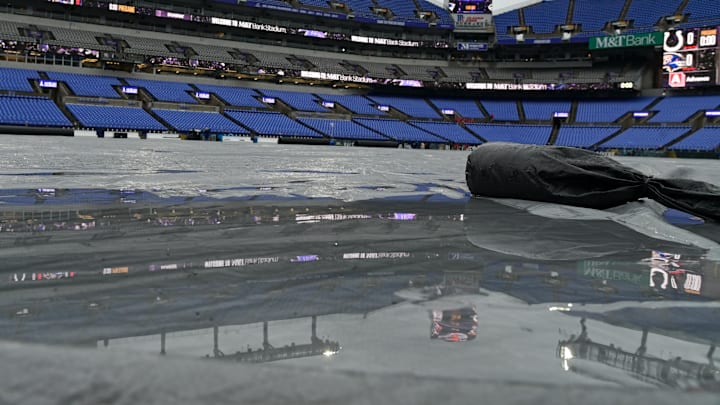 Sep 24, 2023; Baltimore, Maryland, USA; Rain collects on the tarp prior to the start of the game