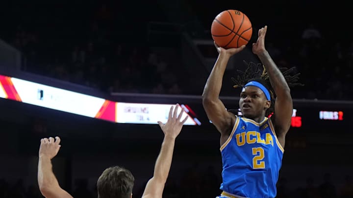Jan 27, 2025; Los Angeles, California, USA; UCLA Bruins guard Dylan Andrews (2) shoots the ball against Southern California Trojans guard Clark Slajchert (32) in the first half at Galen Center. Mandatory Credit: Kirby Lee-Imagn Images