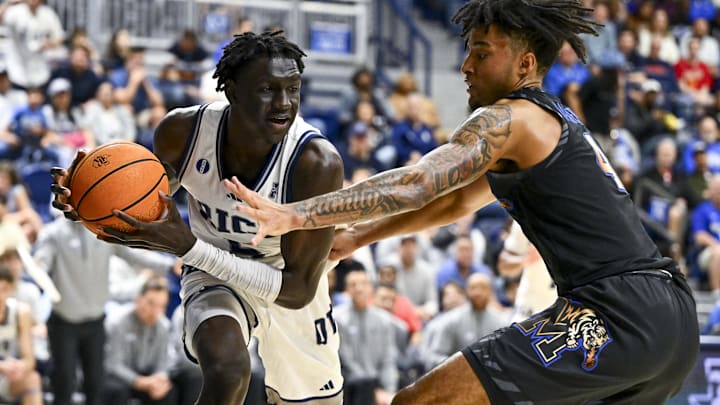 Rice  guard Jacob Dar (5) grabs a rebound away from Memphis guard PJ Haggerty.