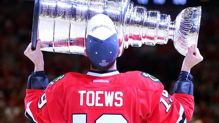 Jun 15, 2015; Chicago, IL, USA; Chicago Blackhawks center Jonathan Toews (19) hoists the Stanley Cup after defeating the Tampa Bay Lightning in game six of the 2015 Stanley Cup Final at United Center. Mandatory Credit: Dennis Wierzbicki-Imagn Images