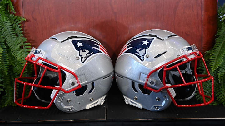 Jan 13, 2025; Foxborough, MA, USA; A pair of New England Patriots helmets sit in front of the podium before a press conference at Gillette Stadium. Mandatory Credit: Eric Canha-Imagn Images Jan 13, 2025; Foxborough, MA, USA; A pair of New England Patriots helmets sit in front of the podium before a press conference at Gillette Stadium. Mandatory Credit: Eric Canha-Imagn Images